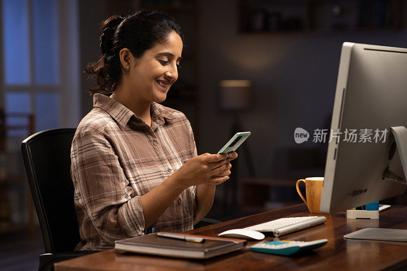 Woman working on computer late at home stock photo stock photo